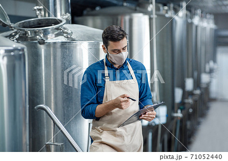 Engineer inspect plant, technician working maintenance and record data on check list 71052440