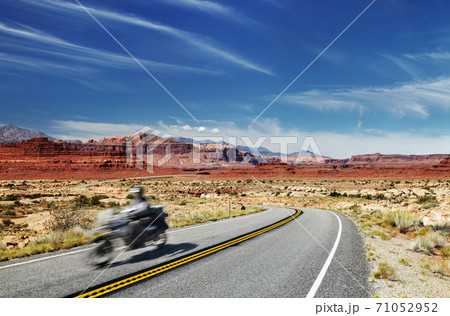 Motorcycle traveler on highway 71052952