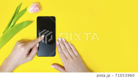 The girl holds the phone in her hand. Flipping through 71053960