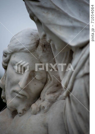 Close up of Jesus's face with eyes closed, Victorian cemetery statue. Close up of Jesus's face with eyes closed, Victorian cemetery statue. 71054064