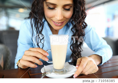 Female person drinking latte Female person drinking latte 71056385