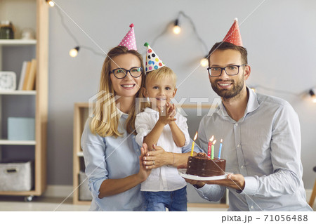 Portrait of happy parents and their little birthday boy at home looking at camera and smiling Portrait of happy parents and their little birthday boy at home looking at camera and smiling 71056488