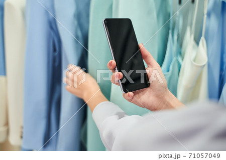 Woman choosing a suit or dress Woman choosing a suit or dress 71057049