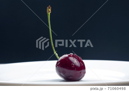 juicy cherry berries lie on a white plate. healthy food for breakfast. fruits of vegetation. juicy cherry berries lie on a white plate. healthy food for breakfast. fruits of vegetation. 71060498