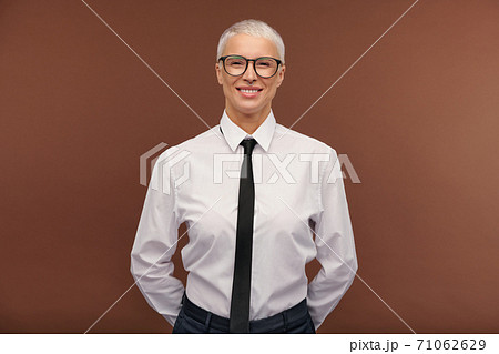 Cheerful manlike blond female in formalwear and eyeglasses looking at you 71062629