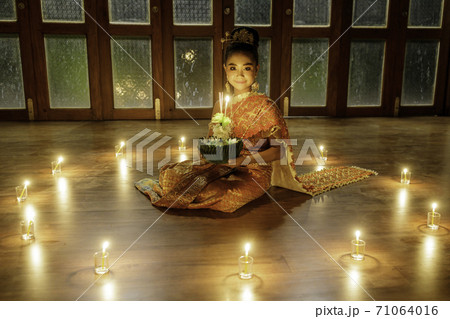 A portrait of a young student, an Asian woman wearing a traditional Thai dress t A portrait of a young student, an Asian woman wearing a traditional Thai dress t 71064016