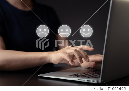 Woman using laptop and emoticon hologram effect. 71065606