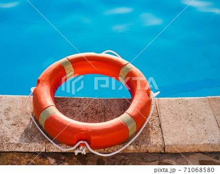 Lifebuoy lying on the background of the pool Lifebuoy lying on the background of the pool 71068580