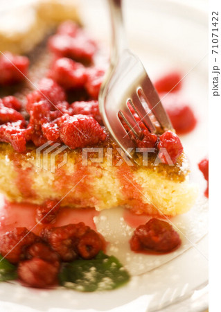 fork on a slice of berries cake fork on a slice of berries cake 71071422