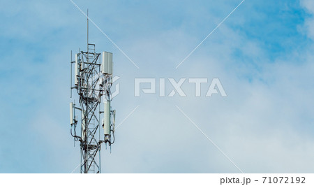Telecommunication tower with blue sky and white clouds background. Antenna on blue sky. Radio and satellite pole. Communication technology. Telecommunication industry. Mobile or telecom 4g network. 71072192