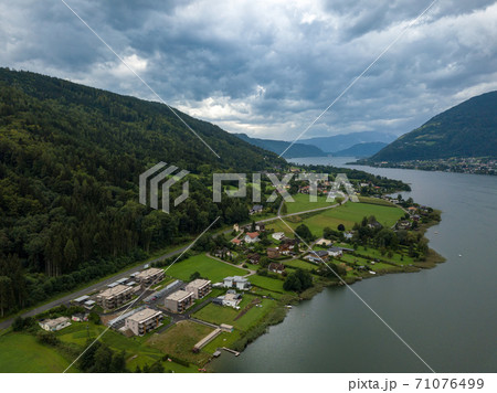 Aerial view on Ossiacher Lake in Carinthia, Austria from Old Ossiach on a cloudy summer day. 71076499