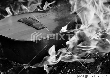 Black and white guitar in flame Black and white guitar in flame 71076573