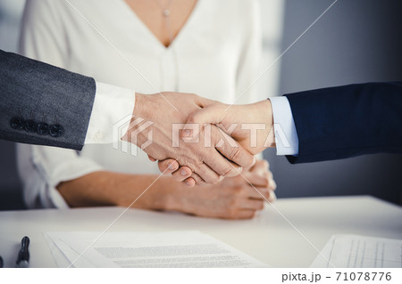 Business people shaking hands finishing contract signing, close-up. Business communication concept. Handshake and marketing Business people shaking hands finishing contract signing, close-up. Business communication concept. Handshake and marketing 71078776