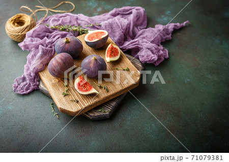 Juicy fig fruits on a dark background 71079381