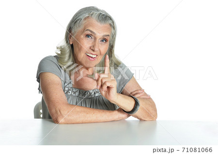Emotional senior woman pointing isolated on white background Emotional senior woman pointing isolated on white background 71081066