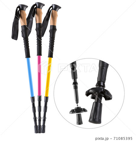 three colored trekking poles stand on a white background, next to them close-up fragment of equipment 71085395