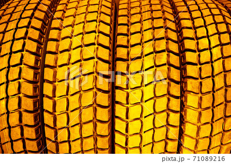 Gold tire tread close-up.The concept of expensive car maintenance. Gold tire tread close-up.The concept of expensive car maintenance. 71089216