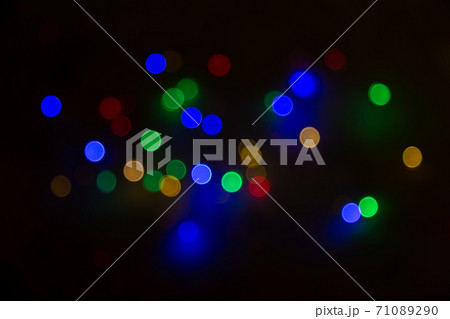 Abstract background, multicolored bokeh on a black background. Abstract background, multicolored bokeh on a black background. 71089290