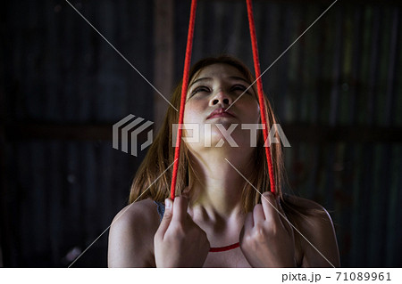 Hopeless Asian woman look and hold gallows Hopeless Asian woman look and hold gallows 71089961