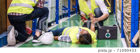 Warehouse worker frist aid after accident panoramic. Warehouse worker frist aid after accident panoramic. 71090433