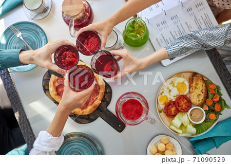 top view on people hands clinking glasses with beverages top view on people hands clinking glasses with beverages 71090529