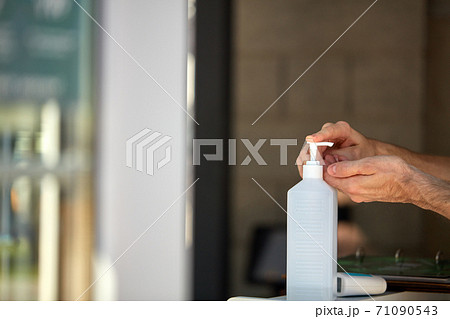 antibacterial hand sanitizer bottle at building entrance for people 71090543