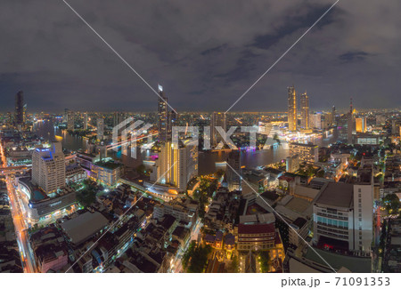 Aerial view of Taksin Bridge with Chao Phraya River, Bangkok Downtown. Thailand. Financial district and business centers in smart urban city. Skyscraper and high-rise buildings at night Aerial view of Taksin Bridge with Chao Phraya River, Bangkok Downtown. Thailand. Financial district and business centers in smart urban city. Skyscraper and high-rise buildings at night 71091353