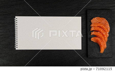 Slices of Raw Salmon Fillet on Black Background Mockup Top View Slices of Raw Salmon Fillet on Black Background Mockup Top View 71092115