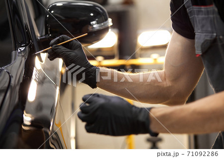 cropped caucasian auto service worker is painting car details cropped caucasian auto service worker is painting car details 71092286