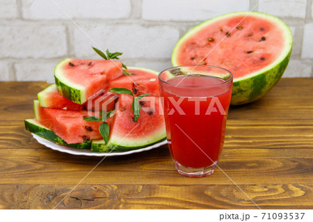 Glass of fresh watermelon juice on a wooden table 71093537