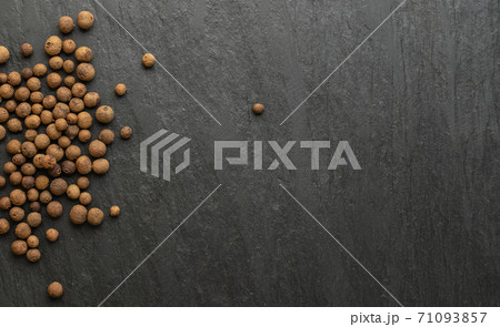 Pile of allspice on black stone background. Jamaica pepper Pile of allspice on black stone background. Jamaica pepper 71093857