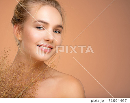 Portrait of young smiling woman with a healthy skin of a face. Happy girl with a spring field flowers Portrait of young smiling woman with a healthy skin of a face. Happy girl with a spring field flowers 71094467