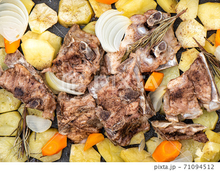 Stewed pork bones with potatoes, onions, carrots, rosemary. Stewed pork bones with potatoes, onions, carrots, rosemary. 71094512