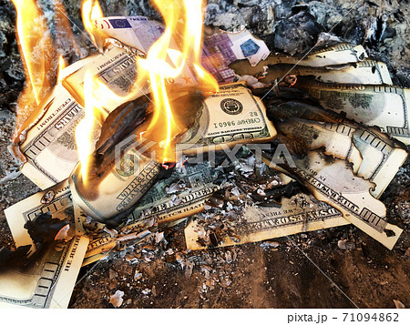 Burning money. Default. Depreciation of currency. Burning dollars on fire 71094862