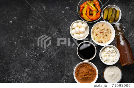 Close up of many fermented foods on black background Close up of many fermented foods on black background 71095006