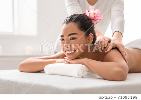 Professional massage advertisement concept. Young woman getting classical body therapy with organic oils at spa. Relaxation and wellness background Professional massage advertisement concept. Young woman getting classical body therapy with organic oils at spa. Relaxation and wellness background 71095198