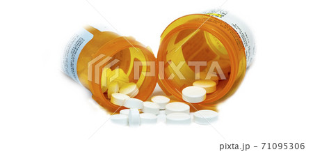 Two pain pill containers with pills spilling out 71095306