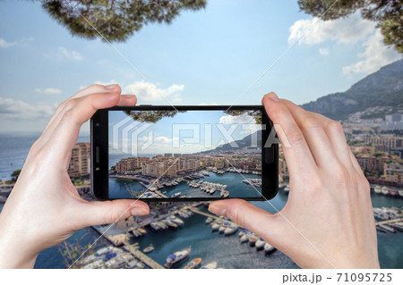 The view of luxury yachts and apartments in Monaco. tourist takes a photo 71095725