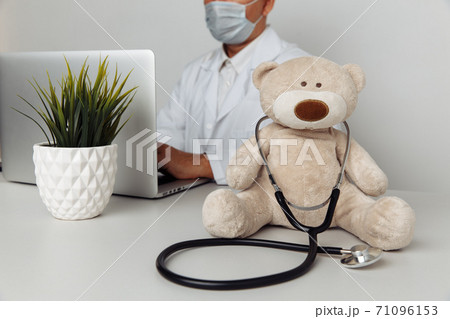 Stuffed Teddy Bear with stethoscope in pediatrician office. Child healtcare concept 71096153