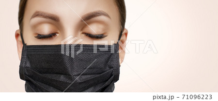 Eyelash Extension Procedure. Beautiful Woman with Extreme Long False Eyelashes. Makeup, Cosmetics. Beauty, Skincare. Woman in medical mask. Eyelash Extension Procedure. Beautiful Woman with Extreme Long False Eyelashes. Makeup, Cosmetics. Beauty, Skincare. Woman in medical mask. 71096223