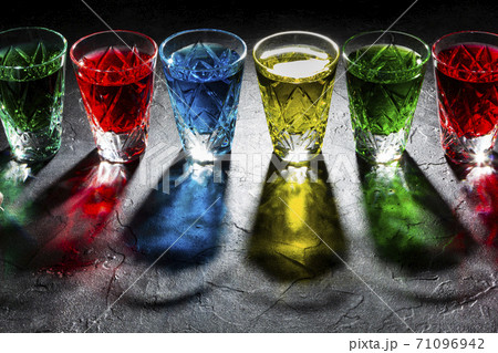 Multicolored shot glasses with Strong alcohol on Dark background Multicolored shot glasses with Strong alcohol on Dark background 71096942