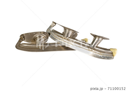 old steel skates isolated on a white background Hockey puck old steel skates isolated on a white background Hockey puck 71100152