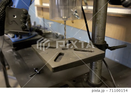 Drilling machine with a drill inserted rotates. Metal drilling. 71100154