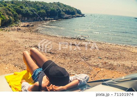 happy woman at sea summer beach sitting at car hood happy woman at sea summer beach sitting at car hood 71101974