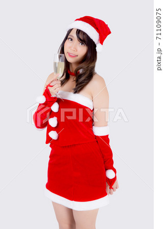 Beautiful portrait young asian woman in Santa holding glass of champagne with party. 71109075