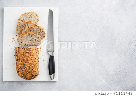 Multigrain bread sliced on a marble board 71111445