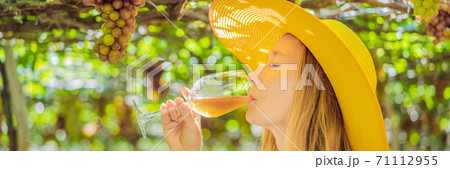 Woman with a glass of wine in the vineyard BANNER, LONG FORMAT Woman with a glass of wine in the vineyard BANNER, LONG FORMAT 71112955