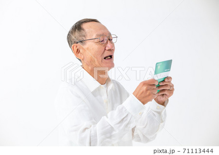 通帳の残高を見るシニア男性 通帳の残高を見るシニア男性 71113444