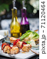 Traditional, oriental and Asian kebabs on a wooden skewer of grilled chicken pieces boiled rice as a garnish. 71120464