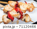 Traditional, oriental and Asian kebabs on a wooden skewer of grilled chicken pieces boiled rice as a garnish. 71120466